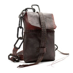 small transparent red horse leather open seam cross body bag with a forged-iron chain link strap and .925 sterling silver zipper pocket on the back, completely handmade in the UK by atelier SKN
