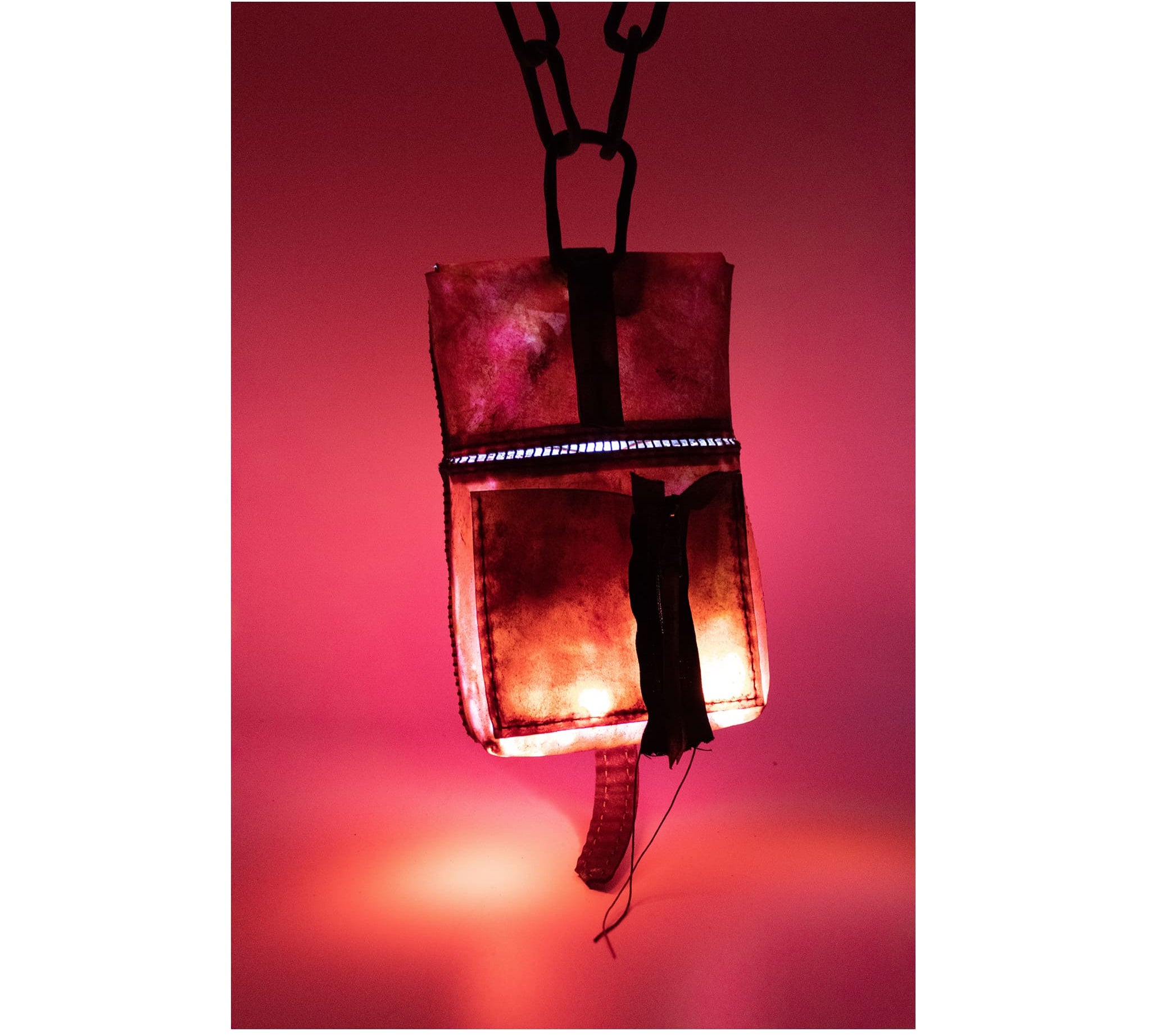 small transparent red horse leather open seam cross body bag with a forged-iron chain link strap and .925 sterling silver zipper pocket on the back, completely handmade in the UK by atelier SKN