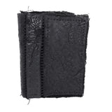object dyed matte black reverse horse culatta leather cardholder, hand stitched over an 18 hour period without the use of machines. the leather bifold card case features multiple card slots, and a french linen lining. an open seam construction is hand stitched in a japanese linen thread. the wallet is available to buy online from avant garde leather studio atelierskn.com