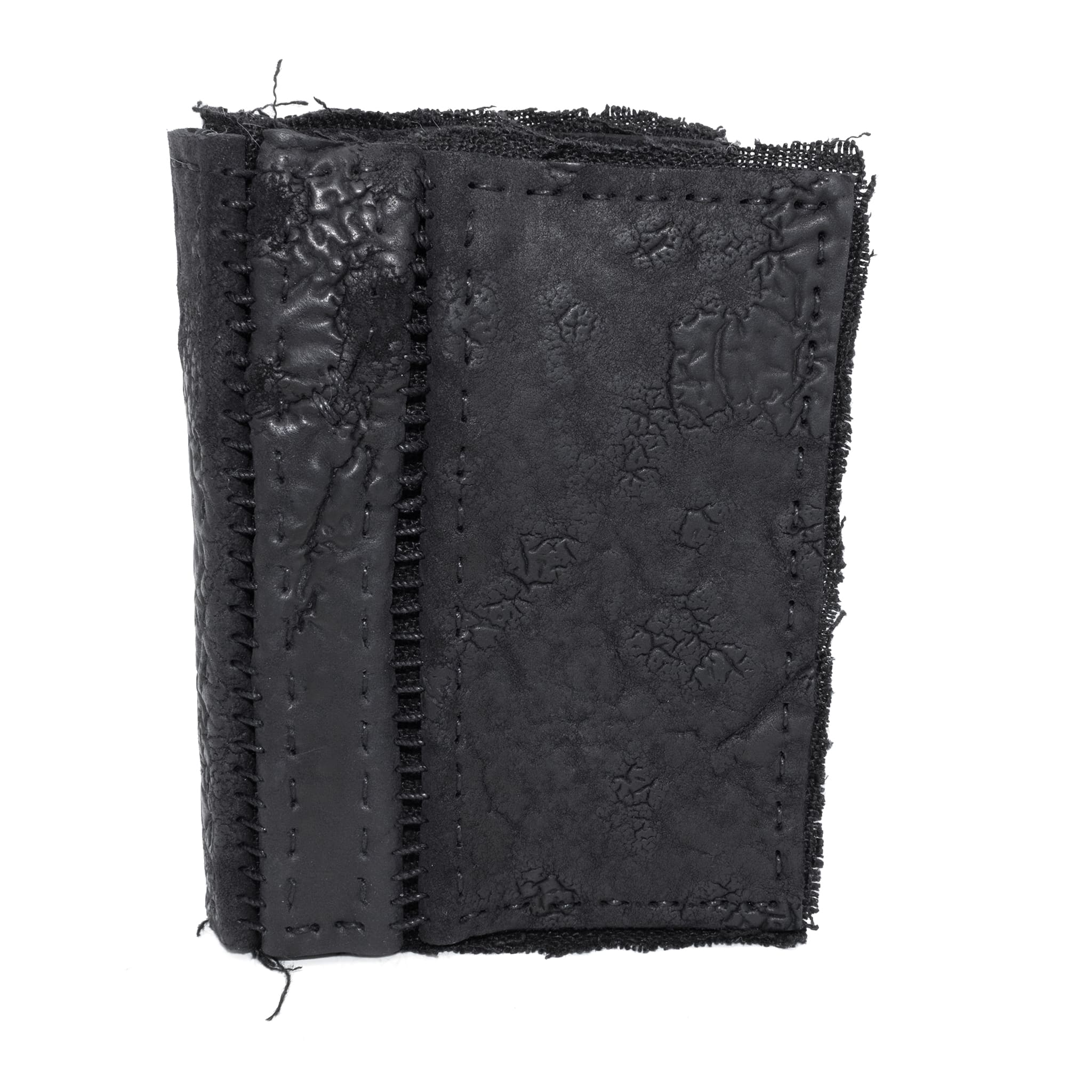 object dyed matte black reverse horse culatta leather cardholder, hand stitched over an 18 hour period without the use of machines. the leather bifold card case features multiple card slots, and a french linen lining. an open seam construction is hand stitched in a japanese linen thread. the wallet is available to buy online from avant garde leather studio atelierskn.com