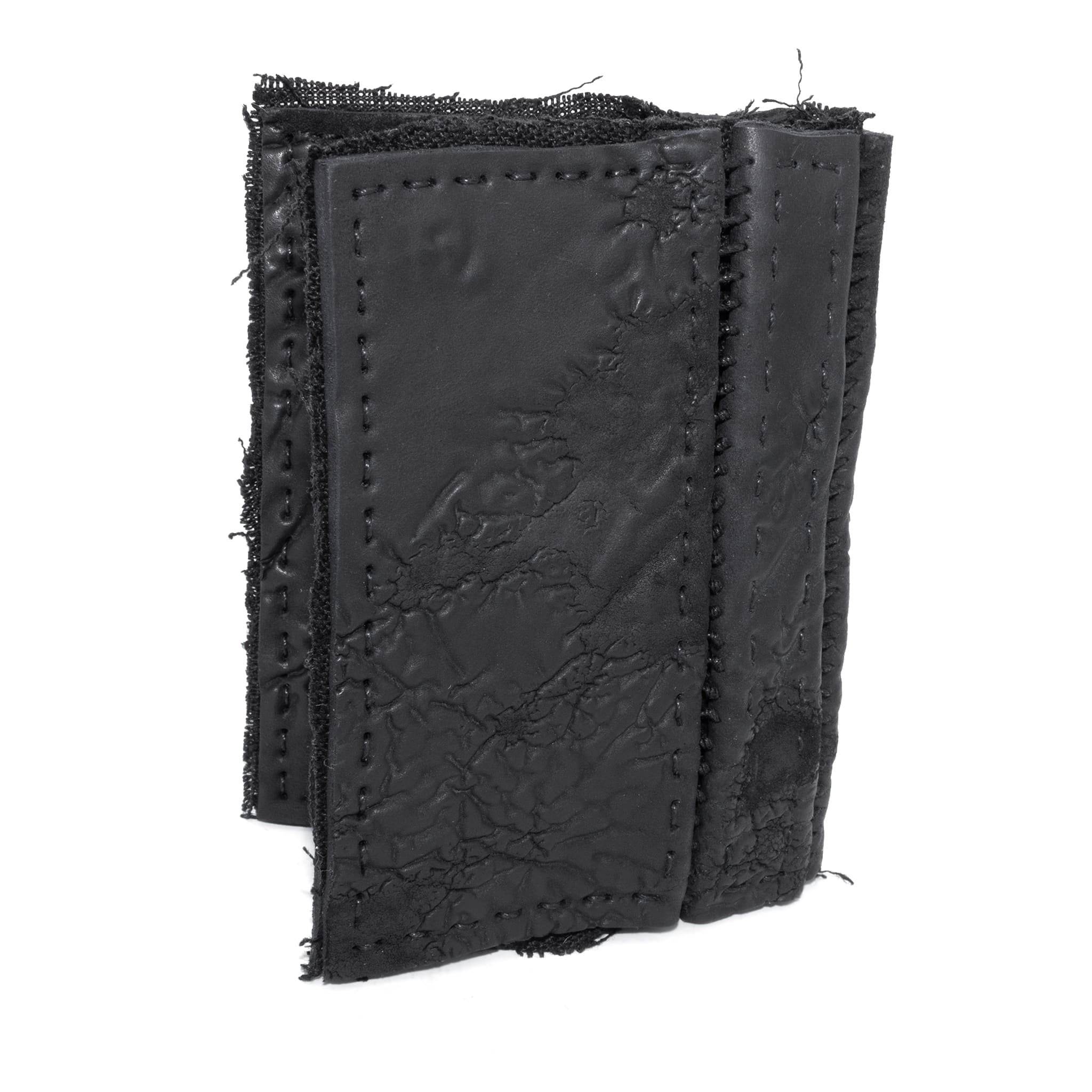 object dyed matte black reverse horse culatta leather cardholder, hand stitched over an 18 hour period without the use of machines. the leather bifold card case features multiple card slots, and a french linen lining. an open seam construction is hand stitched in a japanese linen thread. the wallet is available to buy online from avant garde leather studio atelierskn.com