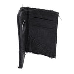 object dyed matte black reverse horse culatta leather cardholder, hand stitched over an 18 hour period without the use of machines. the leather bifold card case features multiple card slots, and a french linen lining. an open seam construction is hand stitched in a japanese linen thread. the wallet is available to buy online from avant garde leather studio atelierskn.com