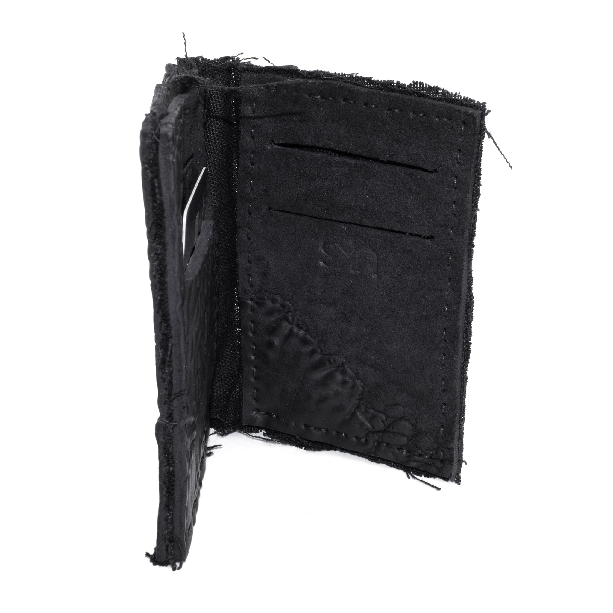 object dyed matte black reverse horse culatta leather cardholder, hand stitched over an 18 hour period without the use of machines. the leather bifold card case features multiple card slots, and a french linen lining. an open seam construction is hand stitched in a japanese linen thread. the wallet is available to buy online from avant garde leather studio atelierskn.com