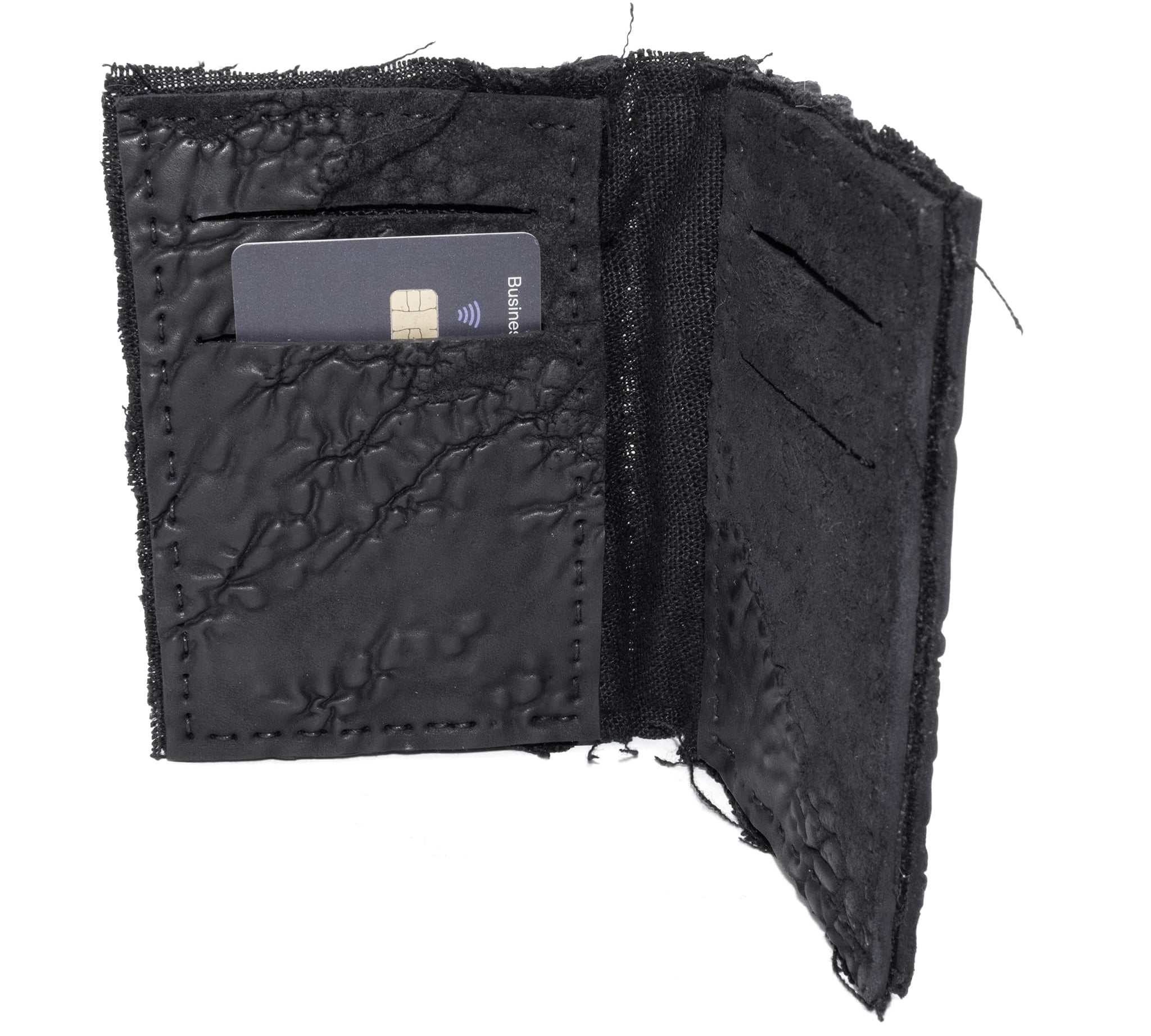 object dyed matte black reverse horse culatta leather cardholder, hand stitched over an 18 hour period without the use of machines. the leather bifold card case features multiple card slots, and a french linen lining. an open seam construction is hand stitched in a japanese linen thread. the wallet is available to buy online from avant garde leather studio atelierskn.com