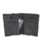 object dyed matte black reverse horse culatta leather cardholder, hand stitched over an 18 hour period without the use of machines. the leather bifold card case features multiple card slots, and a french linen lining. an open seam construction is hand stitched in a japanese linen thread. the wallet is available to buy online from avant garde leather studio atelierskn.com