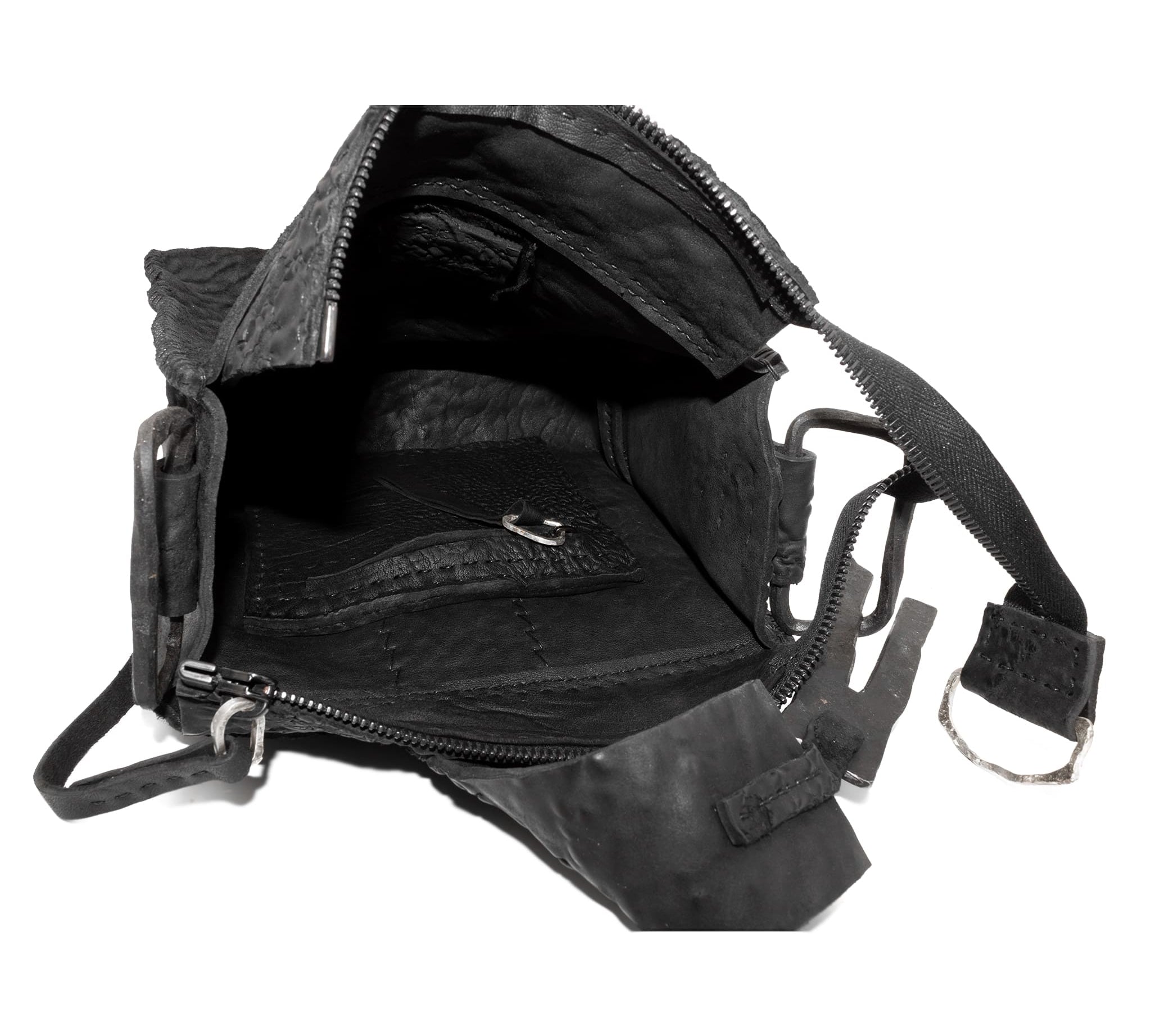 a mini box bag patterned from a full grain reverse horse culatta leather and hand stitched with a japanese linen thread without the use of machines. the bag features a riri zipper closure, double layer hand stitched detachable shoulder strap and hand forged iron and .925 sterling silver hardware. the interior pocket is adorned with a riri zipper and solid .925 sterling silver zipper pull. available from avant garde leather studio atelierskn.com