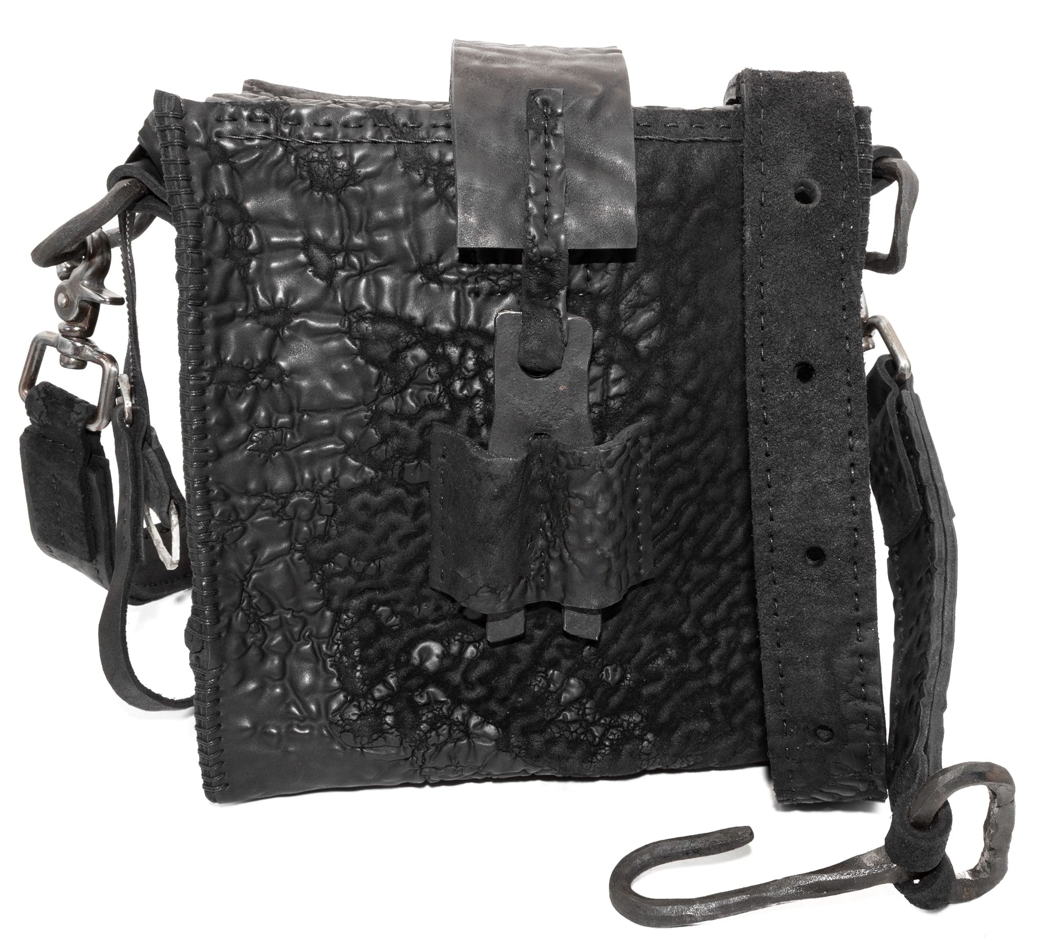 a mini box bag patterned from a full grain reverse horse culatta leather and hand stitched with a japanese linen thread without the use of machines. the bag features a riri zipper closure, double layer hand stitched detachable shoulder strap and hand forged iron and .925 sterling silver hardware. the interior pocket is adorned with a riri zipper and solid .925 sterling silver zipper pull. available from avant garde leather studio atelierskn.com