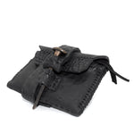 a zipper pocket cardholder crafted from a butter soft reverse horse culatta leather with a matte black object dyed finish in a single piece pattern construction. a riri zipper pocket is adorned with a hand forged solid .925sterling silver zipper pull, which compliments the hand forged solid bronze nail closure, available to buy online from artisanal leather studio atelierskn.com