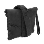 a zipper pocket cardholder crafted from a butter soft reverse horse culatta leather with a matte black object dyed finish in a single piece pattern construction. a riri zipper pocket is adorned with a hand forged solid .925sterling silver zipper pull, which compliments the hand forged solid bronze nail closure, available to buy online from artisanal leather studio atelierskn.com