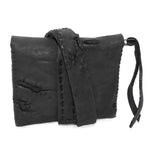 a zipper pocket cardholder crafted from a butter soft reverse horse culatta leather with a matte black object dyed finish in a single piece pattern construction. a riri zipper pocket is adorned with a hand forged solid .925sterling silver zipper pull, which compliments the hand forged solid bronze nail closure, available to buy online from artisanal leather studio atelierskn.com