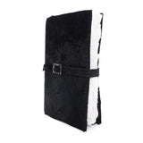 Hand stitched matte black reverse horse culatta leather journal cover with a hand forged solid .925 sterling silver buckle closure and multiple pages of 150gsm handmade cotton rag paper. available to buy online from artisanal uk based leather studio atelier skn.