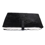 Hand stitched matte black reverse horse culatta leather journal cover with a hand forged solid .925 sterling silver buckle closure and multiple pages of 150gsm handmade cotton rag paper. available to buy online from artisanal uk based leather studio atelier skn.