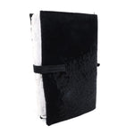Hand stitched matte black reverse horse culatta leather journal cover with a hand forged solid .925 sterling silver buckle closure and multiple pages of 150gsm handmade cotton rag paper. available to buy online from artisanal uk based leather studio atelier skn.