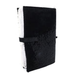 Hand stitched matte black reverse horse culatta leather journal cover with a hand forged solid .925 sterling silver buckle closure and multiple pages of 150gsm handmade cotton rag paper. available to buy online from artisanal uk based leather studio atelier skn.