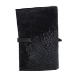 Hand stitched matte black reverse horse culatta leather journal cover with a hand forged solid .925 sterling silver buckle closure and multiple pages of 150gsm handmade cotton rag paper. available to buy online from artisanal uk based leather studio atelier skn.