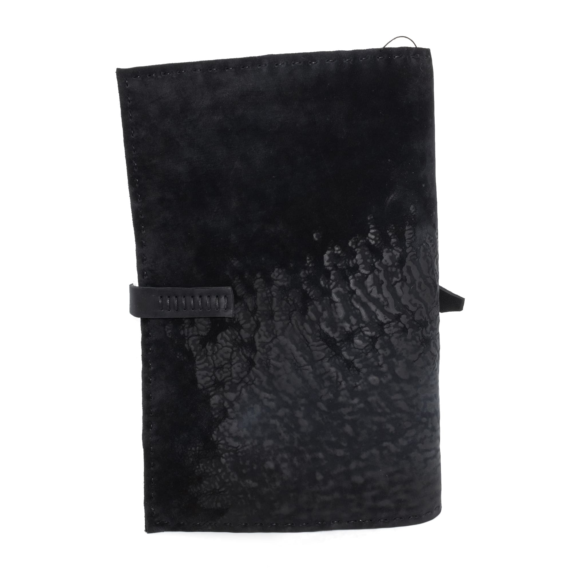 Hand stitched matte black reverse horse culatta leather journal cover with a hand forged solid .925 sterling silver buckle closure and multiple pages of 150gsm handmade cotton rag paper. available to buy online from artisanal uk based leather studio atelier skn.