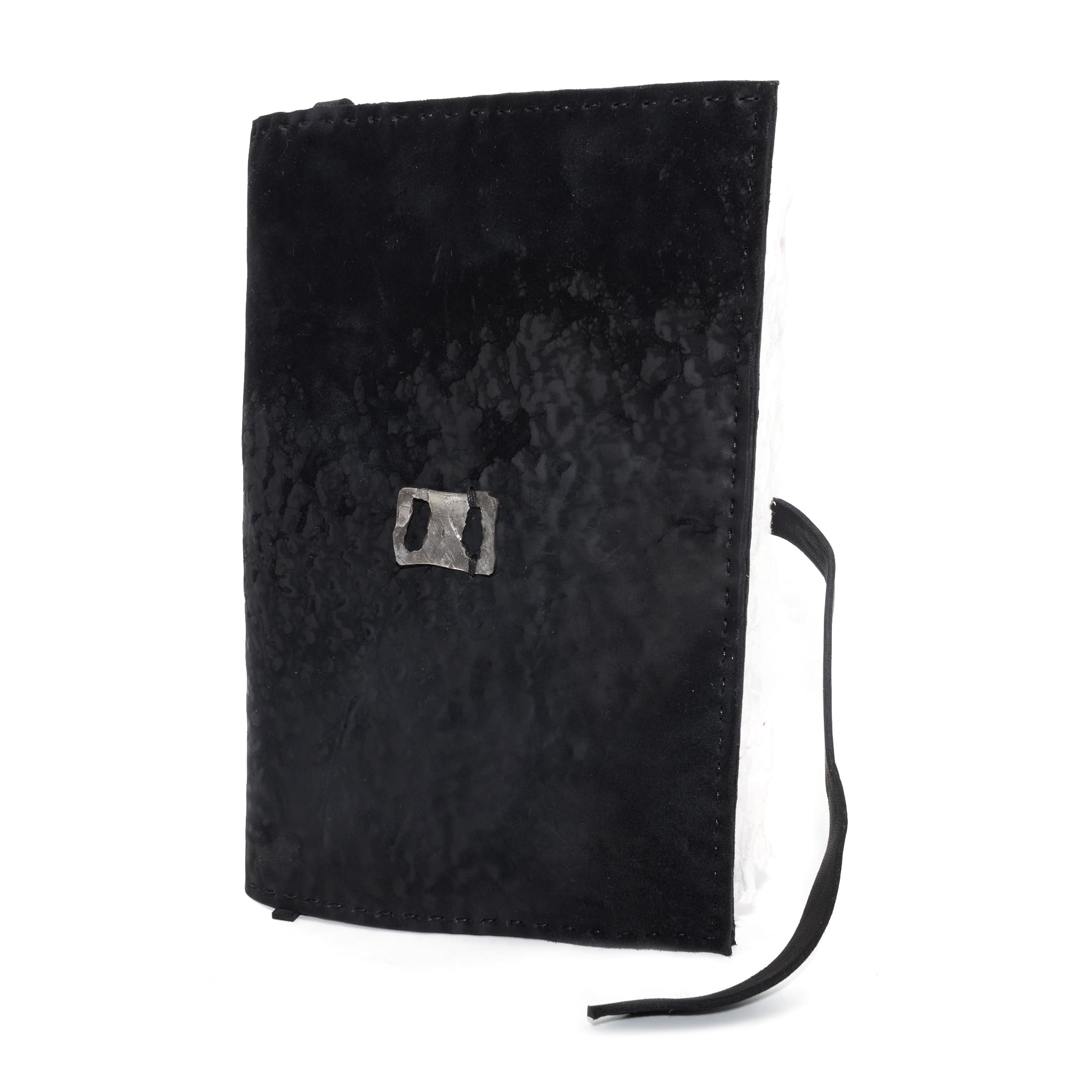 Hand stitched matte black reverse horse culatta leather journal cover with a hand forged solid .925 sterling silver buckle closure and multiple pages of 150gsm handmade cotton rag paper. available to buy online from artisanal uk based leather studio atelier skn.