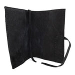 Hand stitched matte black reverse horse culatta leather journal cover with a hand forged solid .925 sterling silver buckle closure and multiple pages of 150gsm handmade cotton rag paper. available to buy online from artisanal uk based leather studio atelier skn.