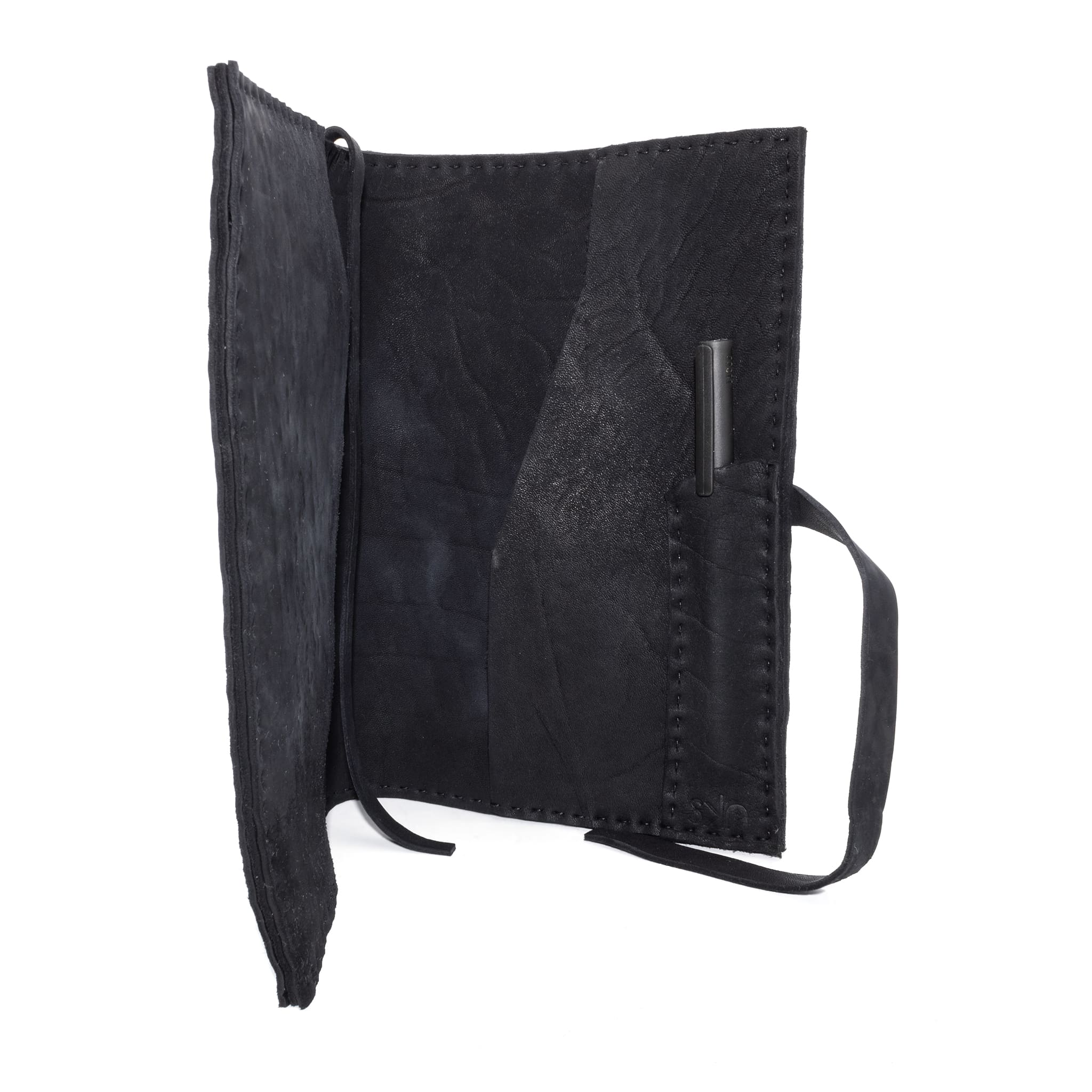 Hand stitched matte black reverse horse culatta leather journal cover with a hand forged solid .925 sterling silver buckle closure and multiple pages of 150gsm handmade cotton rag paper. available to buy online from artisanal uk based leather studio atelier skn.