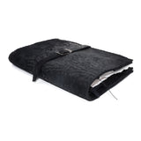 Hand stitched matte black reverse horse culatta leather journal cover with a hand forged solid .925 sterling silver buckle closure and multiple pages of 150gsm handmade cotton rag paper. available to buy online from artisanal uk based leather studio atelier skn.