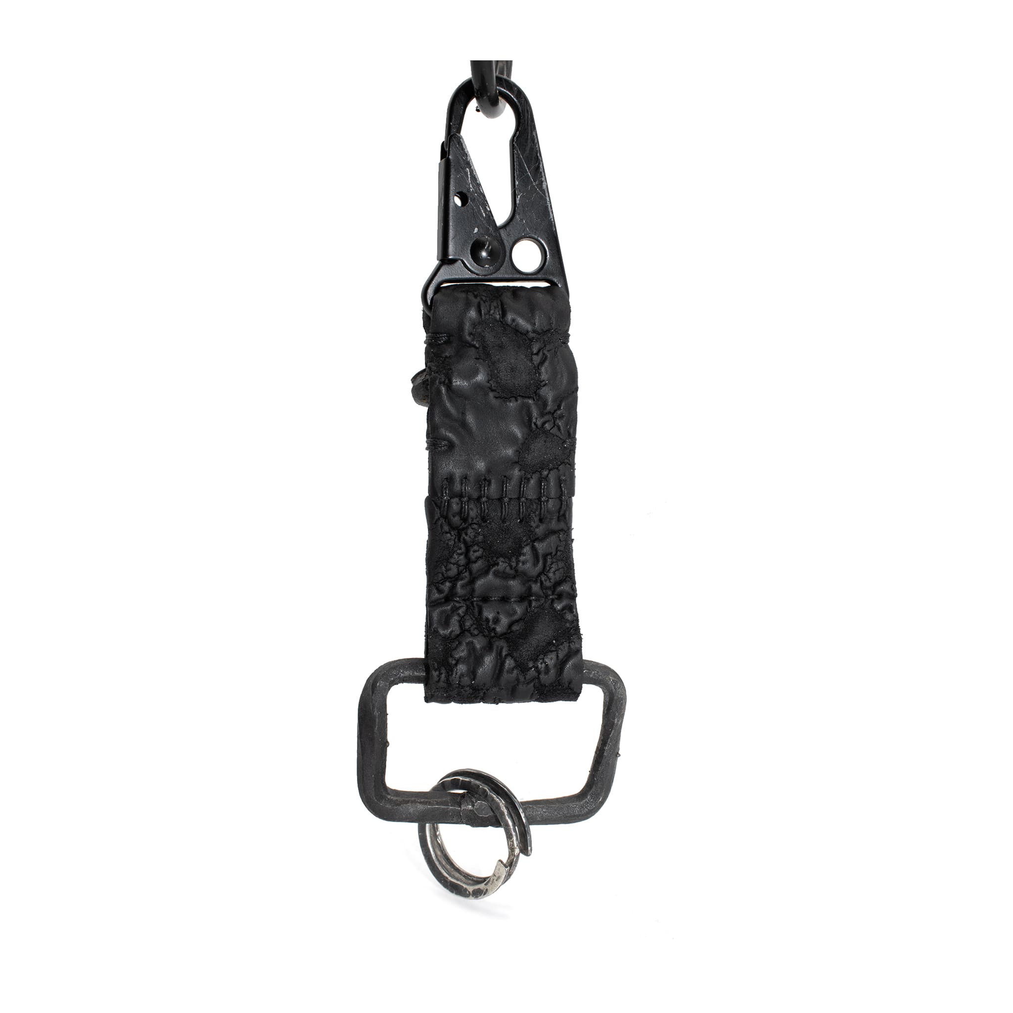 hand stitched and hand dyed reverse horse culatta leather keychain adorned with hand forged iron and .925 sterling silver hardware. a distressed military clip and overlock stitching finish off the keychain. available online from artisanal leather studio atelier skn.