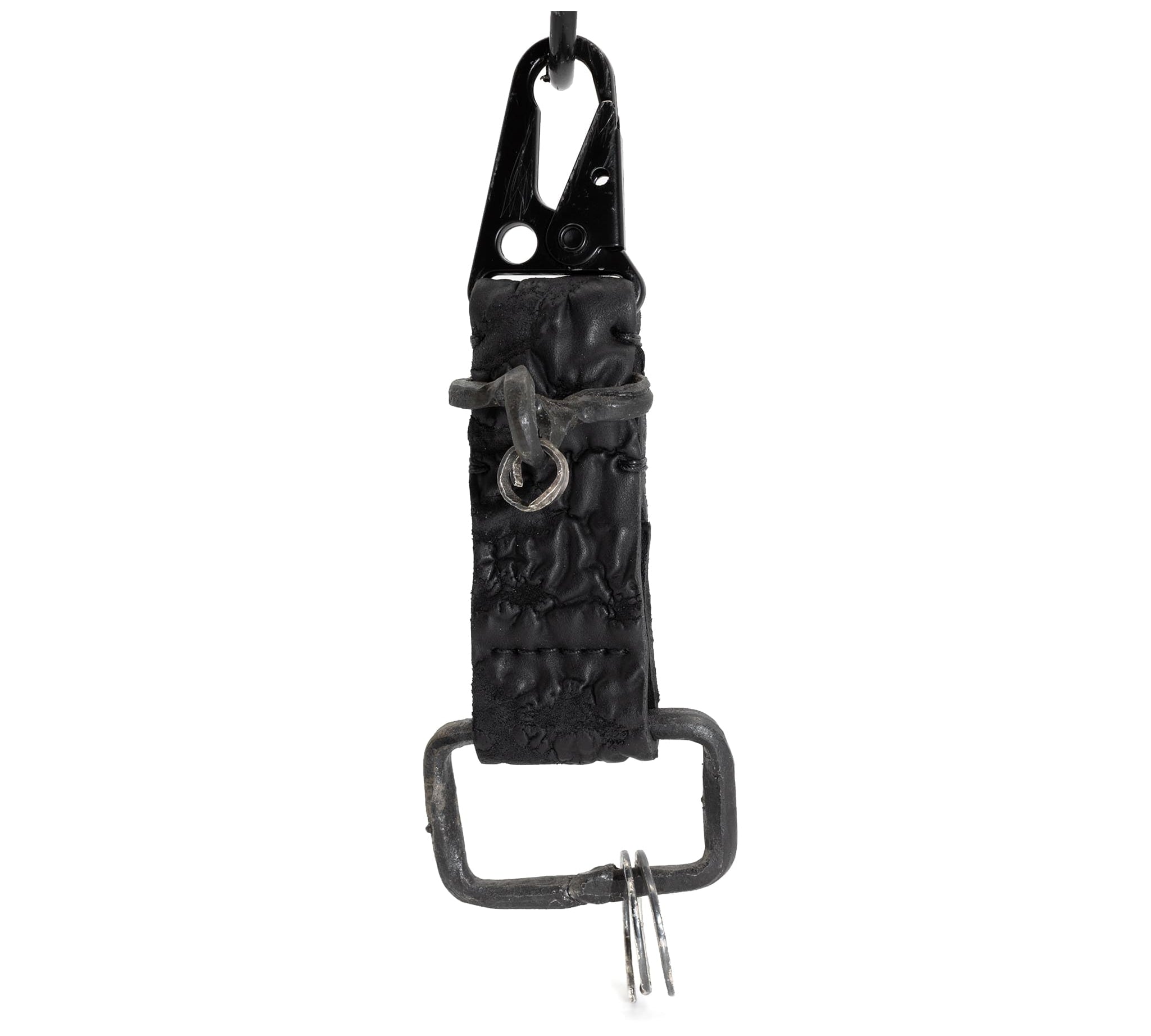 hand stitched and hand dyed reverse horse culatta leather keychain adorned with hand forged iron and .925 sterling silver hardware. a distressed military clip and overlock stitching finish off the keychain. available online from artisanal leather studio atelier skn.