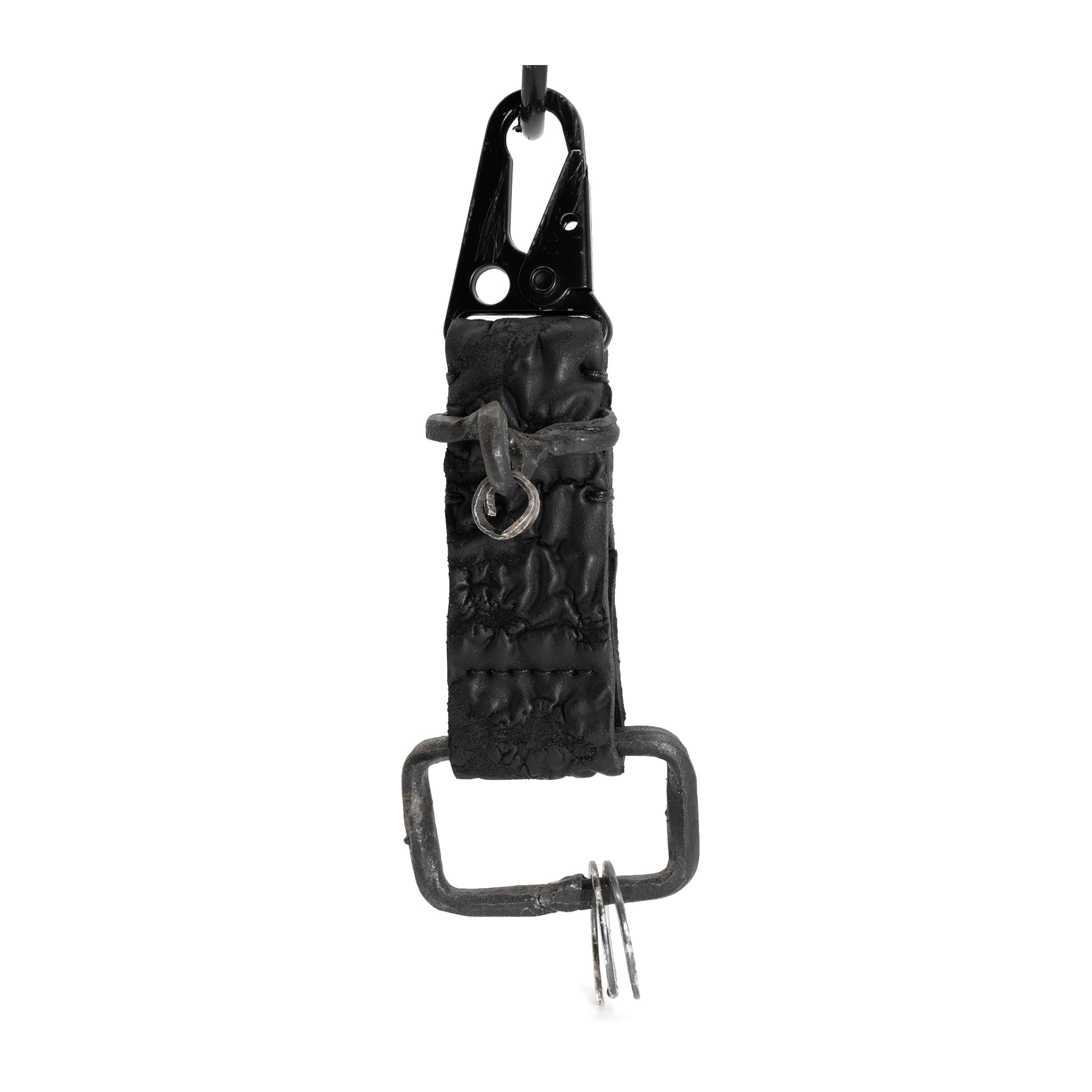 hand stitched and hand dyed reverse horse culatta leather keychain adorned with hand forged iron and .925 sterling silver hardware. a distressed military clip and overlock stitching finish off the keychain. available online from artisanal leather studio atelier skn.