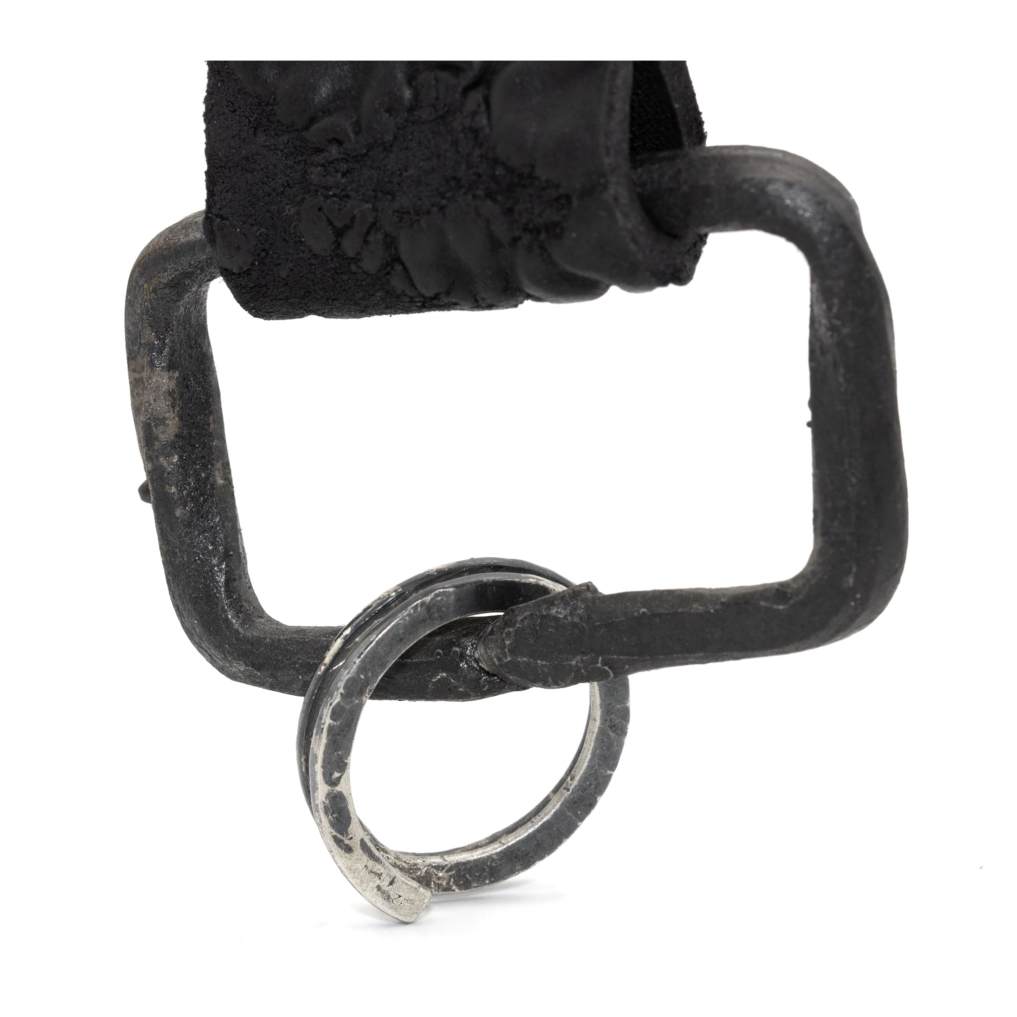 hand stitched and hand dyed reverse horse culatta leather keychain adorned with hand forged iron and .925 sterling silver hardware. a distressed military clip and overlock stitching finish off the keychain. available online from artisanal leather studio atelier skn.