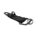 hand stitched and hand dyed reverse horse culatta leather keychain adorned with hand forged iron and .925 sterling silver hardware. a distressed military clip and overlock stitching finish off the keychain. available online from artisanal leather studio atelier skn.