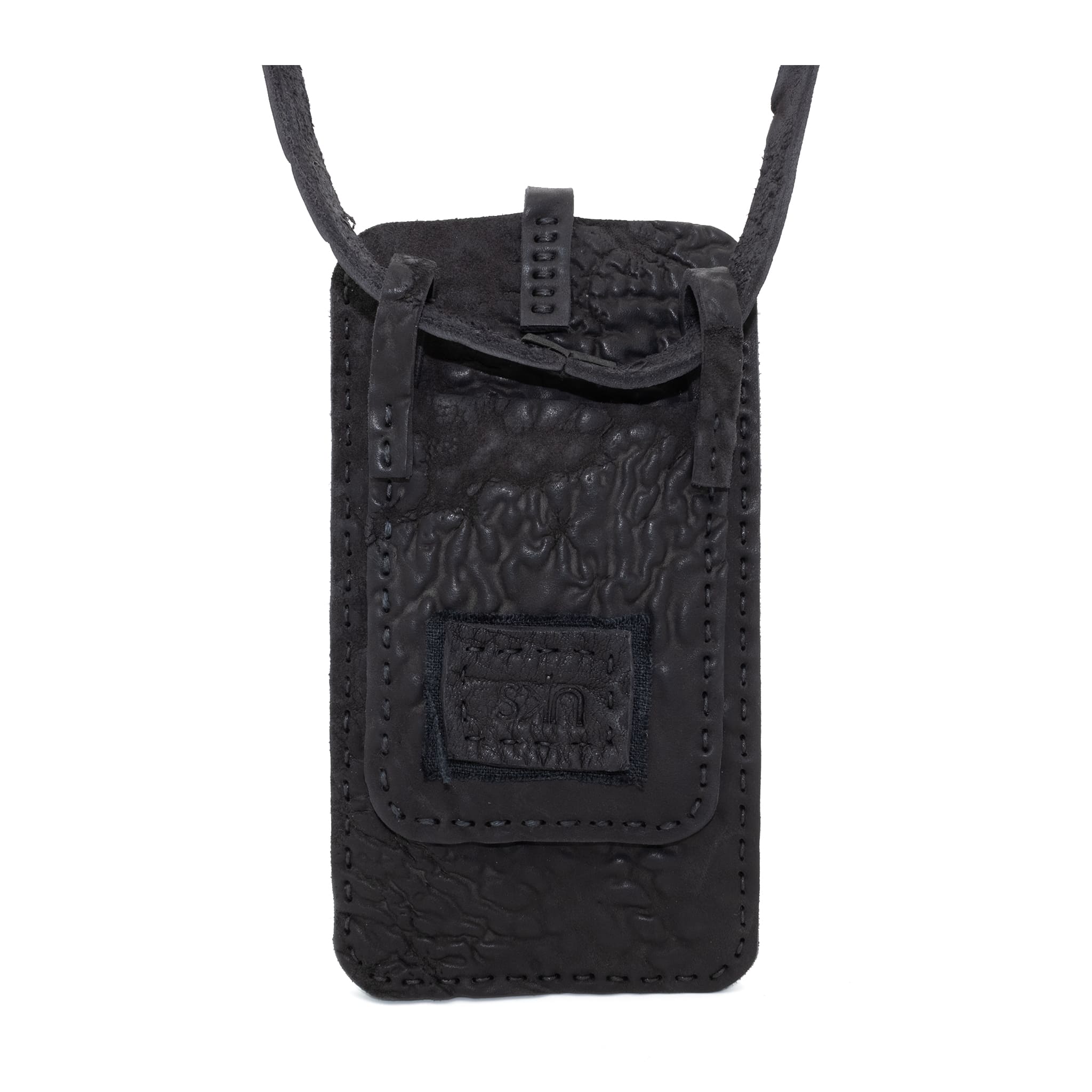 meticulously hand stitched, the washed reverse horse culatta leather phone case features a minimal silhouette, with a distressed iron dye treatment, tonal linen stitching and a card slot to the rear. the phone holder is available to buy online from avant garde designer atelierskn.com 