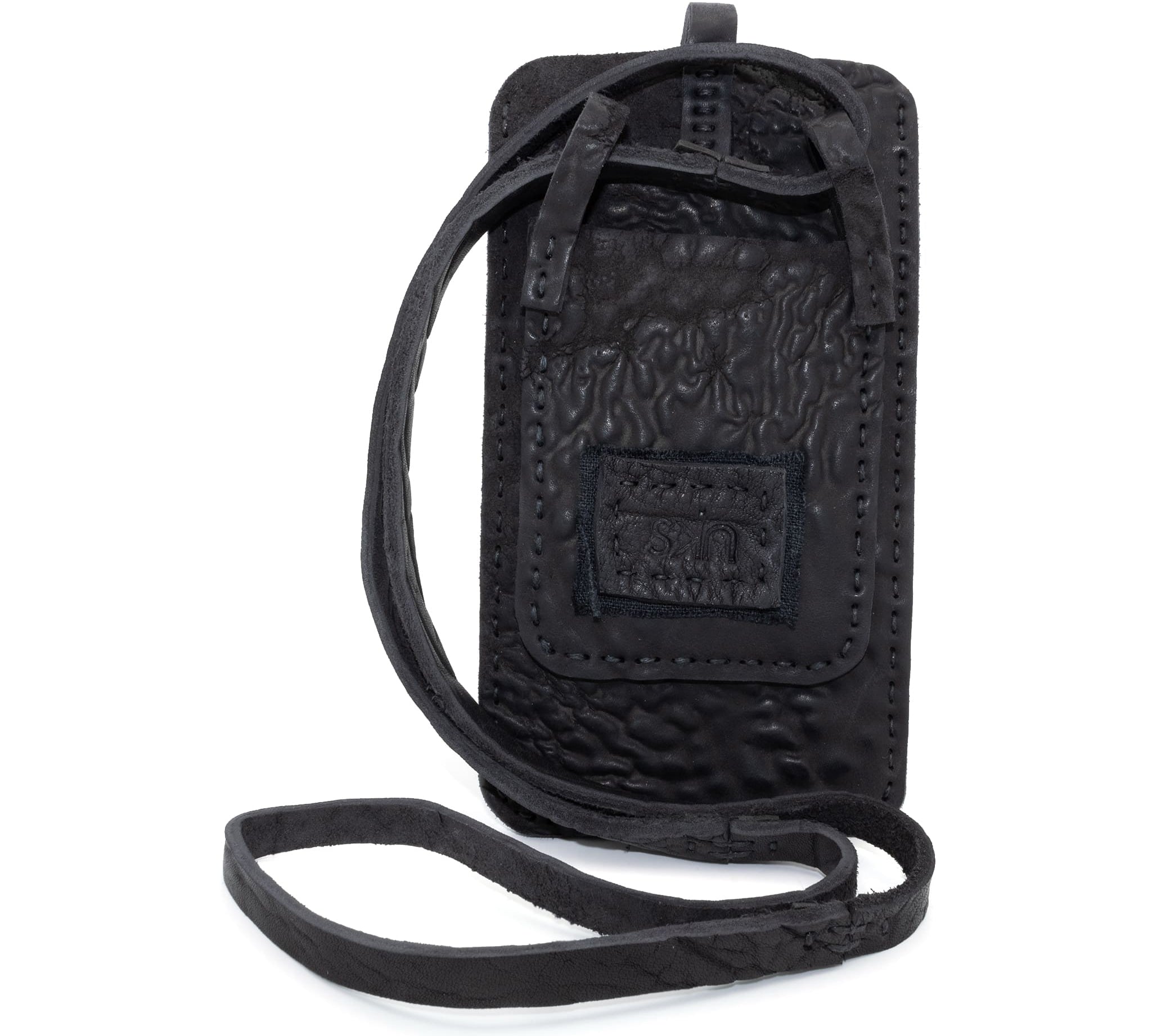 meticulously hand stitched, the washed reverse horse culatta leather phone case features a minimal silhouette, with a distressed iron dye treatment, tonal linen stitching and a card slot to the rear. the phone holder is available to buy online from avant garde designer atelierskn.com 