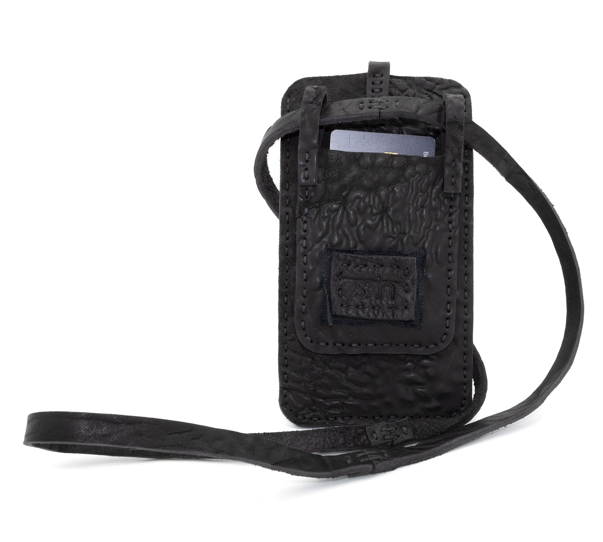 meticulously hand stitched, the washed reverse horse culatta leather phone case features a minimal silhouette, with a distressed iron dye treatment, tonal linen stitching and a card slot to the rear. the phone holder is available to buy online from avant garde designer atelierskn.com 