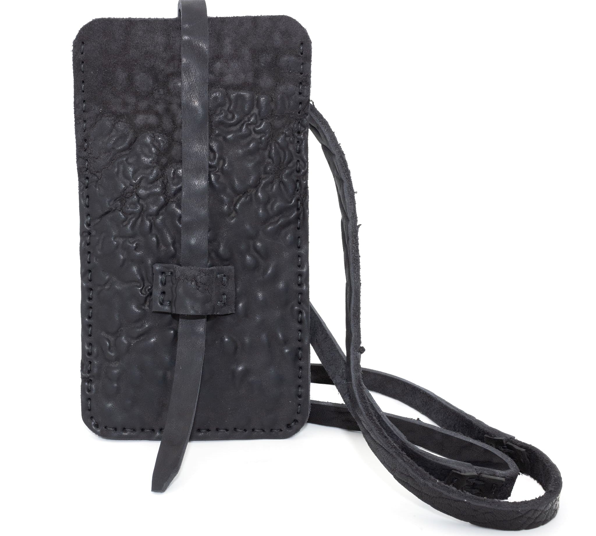 meticulously hand stitched, the washed reverse horse culatta leather phone case features a minimal silhouette, with a distressed iron dye treatment, tonal linen stitching and a card slot to the rear. the phone holder is available to buy online from avant garde designer atelierskn.com 