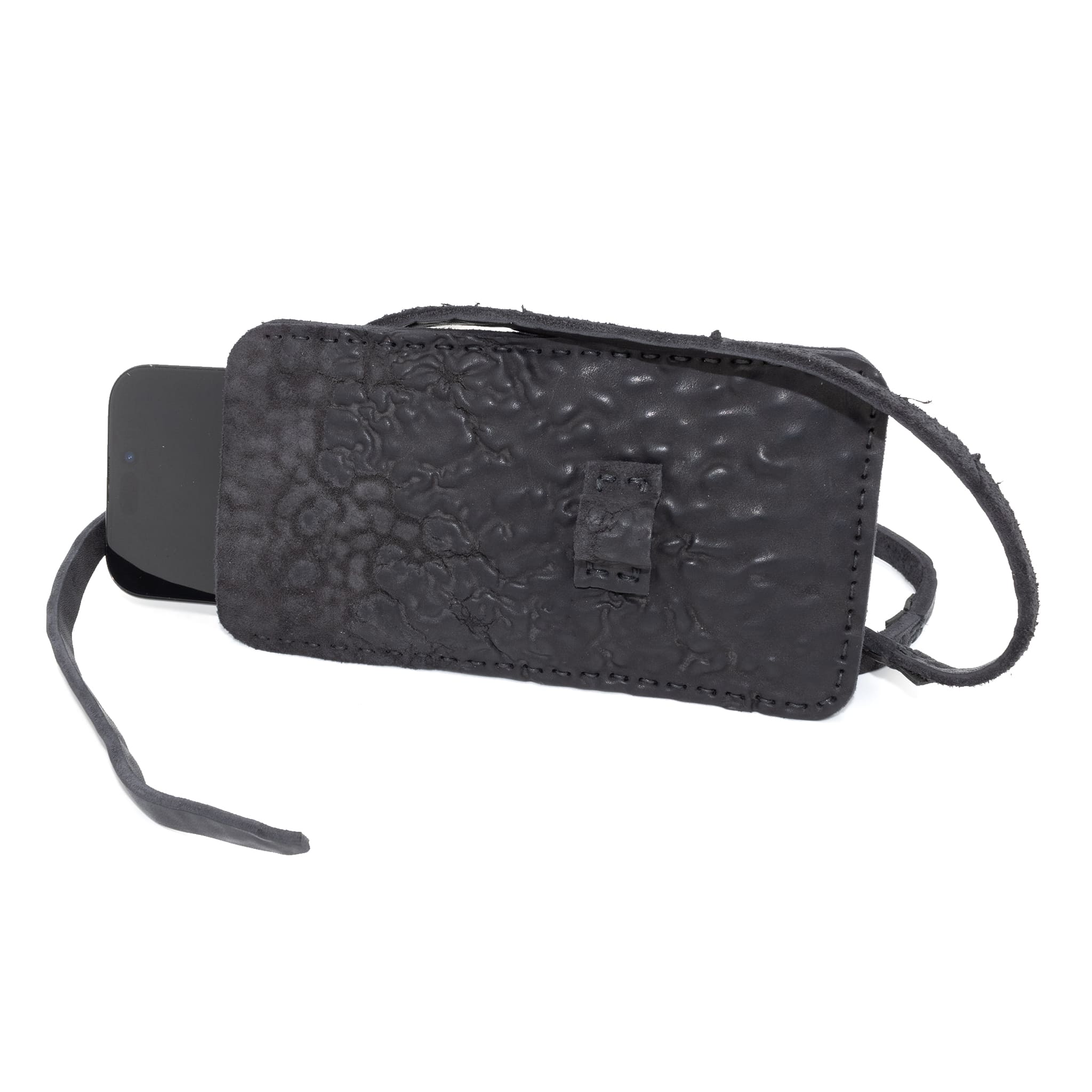 meticulously hand stitched, the washed reverse horse culatta leather phone case features a minimal silhouette, with a distressed iron dye treatment, tonal linen stitching and a card slot to the rear. the phone holder is available to buy online from avant garde designer atelierskn.com 