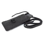 meticulously hand stitched, the washed reverse horse culatta leather phone case features a minimal silhouette, with a distressed iron dye treatment, tonal linen stitching and a card slot to the rear. the phone holder is available to buy online from avant garde designer atelierskn.com 