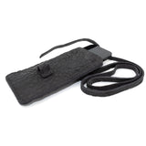 meticulously hand stitched, the washed reverse horse culatta leather phone case features a minimal silhouette, with a distressed iron dye treatment, tonal linen stitching and a card slot to the rear. the phone holder is available to buy online from avant garde designer atelierskn.com 