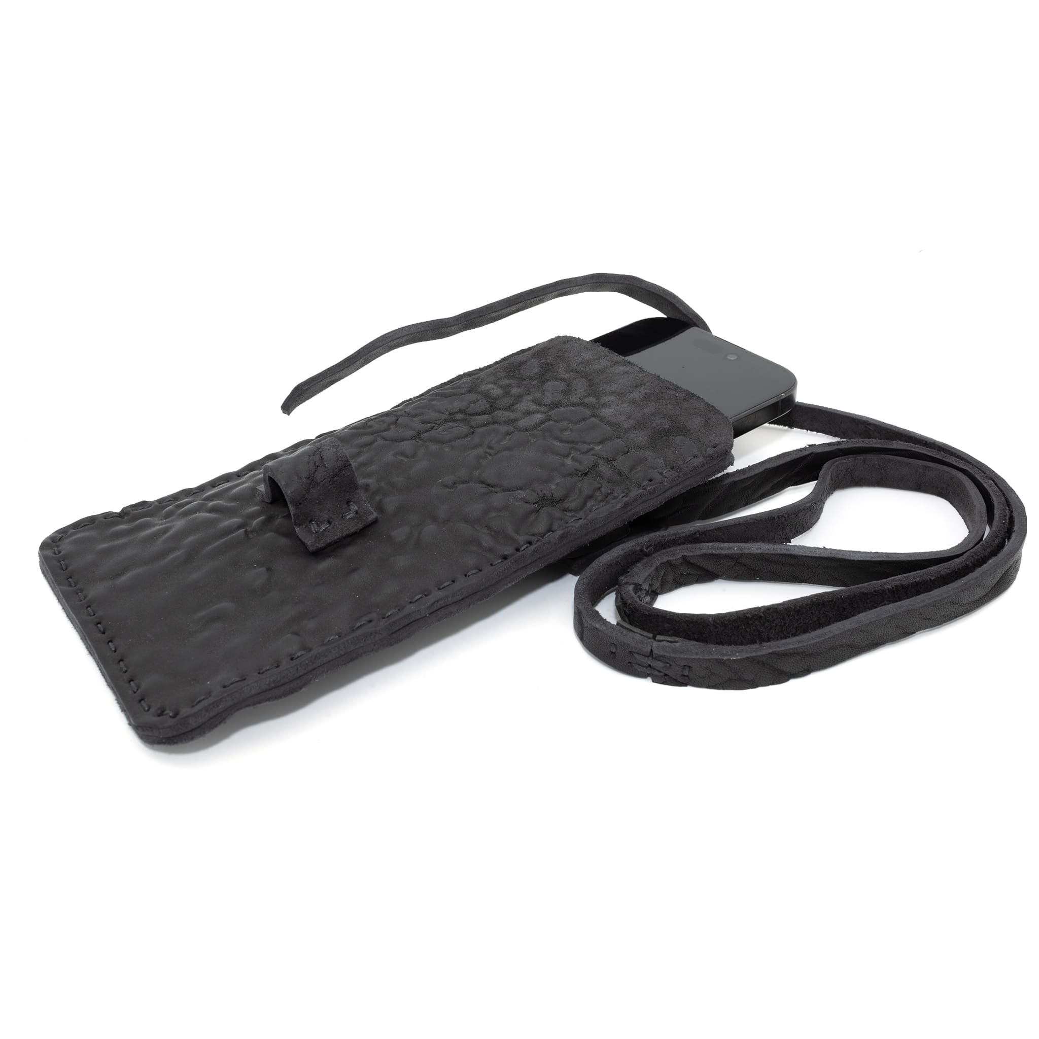 meticulously hand stitched, the washed reverse horse culatta leather phone case features a minimal silhouette, with a distressed iron dye treatment, tonal linen stitching and a card slot to the rear. the phone holder is available to buy online from avant garde designer atelierskn.com 