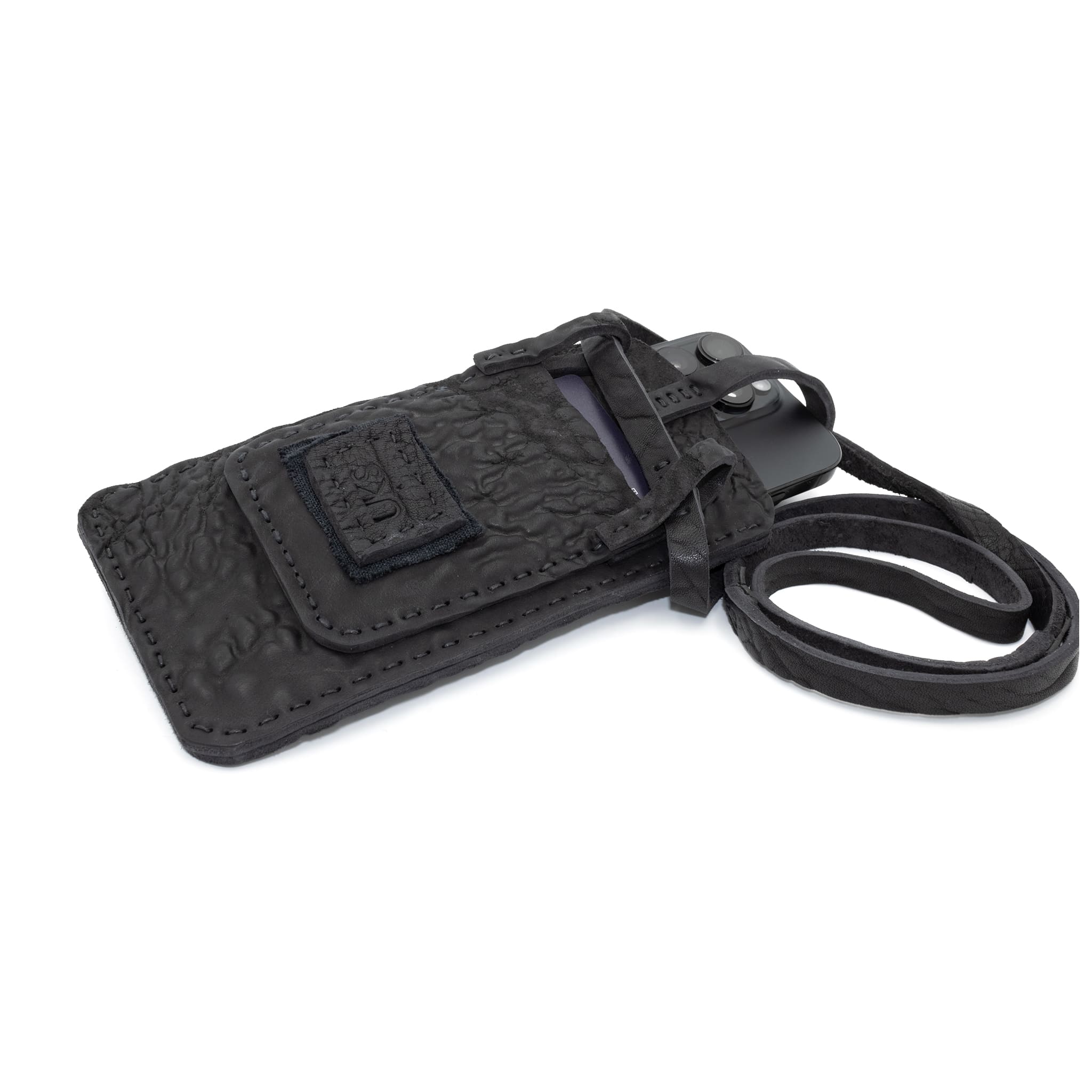 meticulously hand stitched, the washed reverse horse culatta leather phone case features a minimal silhouette, with a distressed iron dye treatment, tonal linen stitching and a card slot to the rear. the phone holder is available to buy online from avant garde designer atelierskn.com 