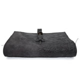 Hand stitched object dyed grey reverse horse culatta leather journal cover with a hand forged solid burnt bronze nail closure, interior pockets and multiple pages of 150gsm handmade cotton rag paper. available to buy online from artisanal uk based leather studio atelier skn.