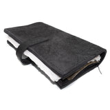 Hand stitched object dyed grey reverse horse culatta leather journal cover with a hand forged solid burnt bronze nail closure, interior pockets and multiple pages of 150gsm handmade cotton rag paper. available to buy online from artisanal uk based leather studio atelier skn.