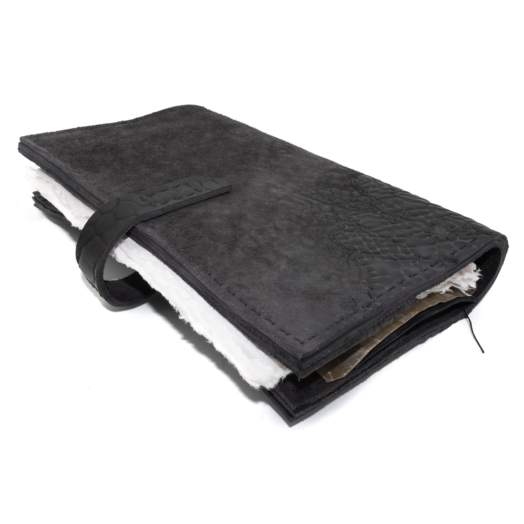 Hand stitched object dyed grey reverse horse culatta leather journal cover with a hand forged solid burnt bronze nail closure, interior pockets and multiple pages of 150gsm handmade cotton rag paper. available to buy online from artisanal uk based leather studio atelier skn.