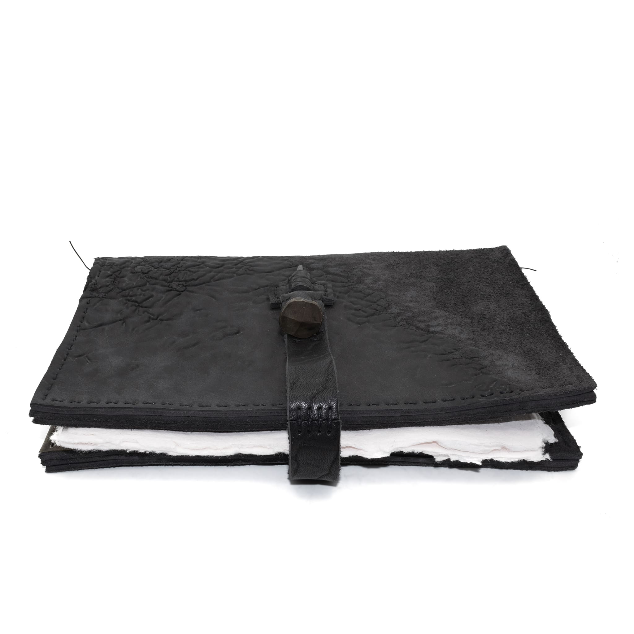 Hand stitched object dyed grey reverse horse culatta leather journal cover with a hand forged solid burnt bronze nail closure, interior pockets and multiple pages of 150gsm handmade cotton rag paper. available to buy online from artisanal uk based leather studio atelier skn.