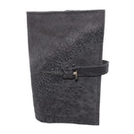 Hand stitched object dyed grey reverse horse culatta leather journal cover with a hand forged solid burnt bronze nail closure, interior pockets and multiple pages of 150gsm handmade cotton rag paper. available to buy online from artisanal uk based leather studio atelier skn.