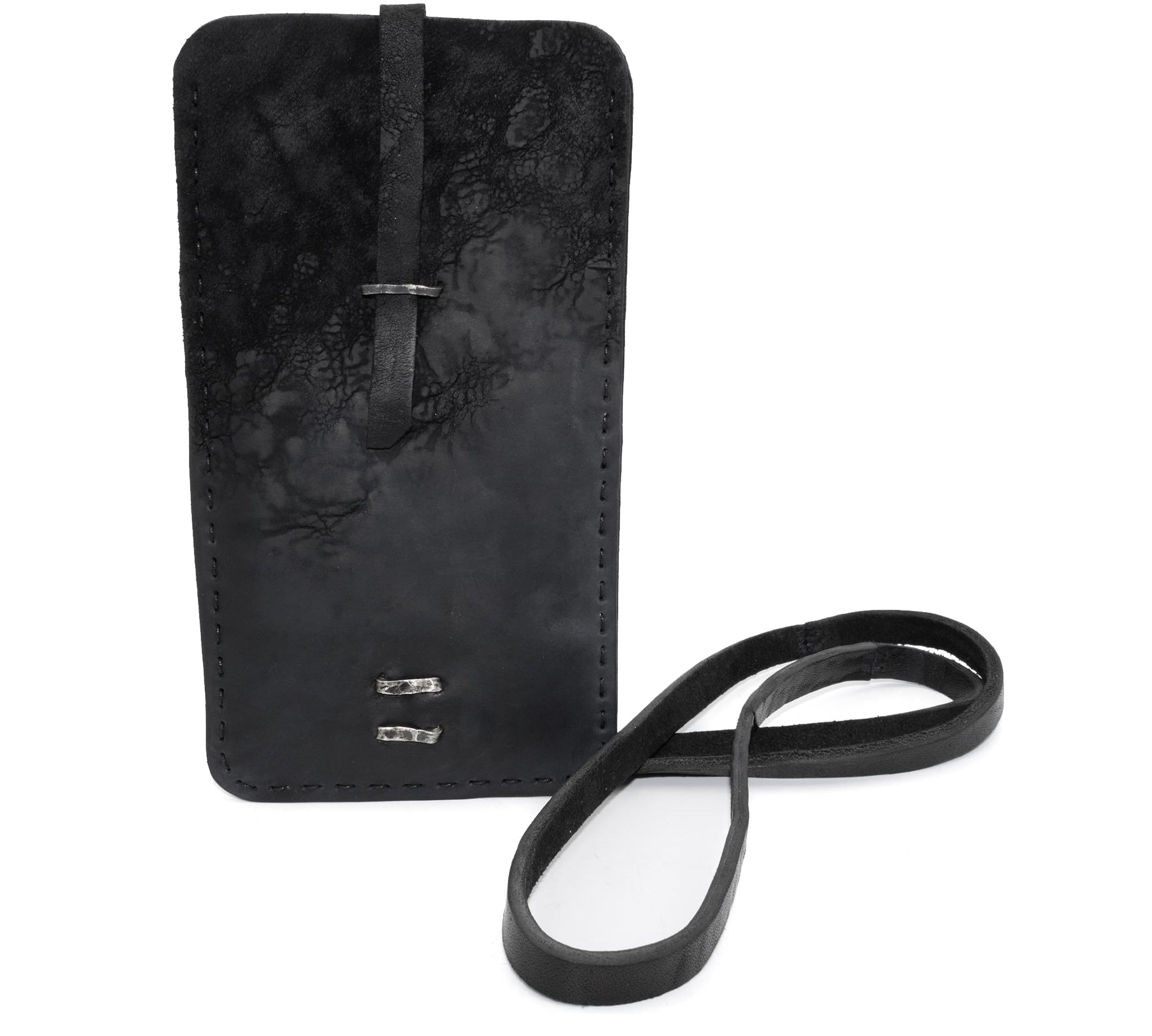 meticulously hand stitched, the washed reverse horse culatta leather phone case features a minimal silhouette, a distressed black dye treatment, tonal linen stitching and hand forged .925 sterling silver details. the phone holder is available to buy online from avant garde designer atelierskn.com 