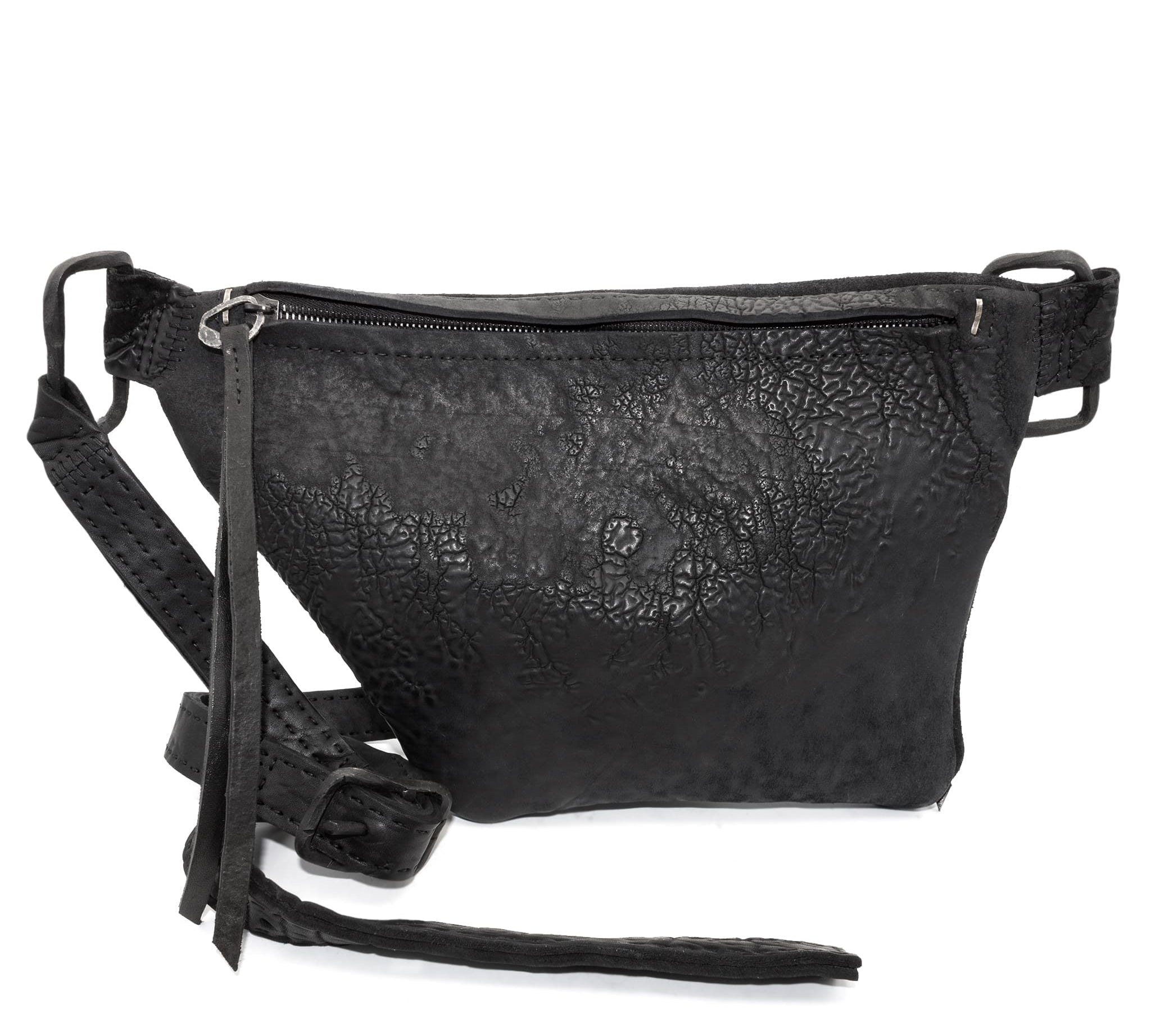 the sling bag is  patterned from a full grain reverse horse culatta leather and hand stitched with a japanese linen thread without the use of machines. the bag features a riri zipper closure, double layer hand stitched shoulder strap and hand forged iron and .925 sterling silver hardware. the rear pocket is linen with a french linen and adorned with a riri zipper and solid .925 sterling silver zipper pull. available from avant garde leather studio atelierskn.com