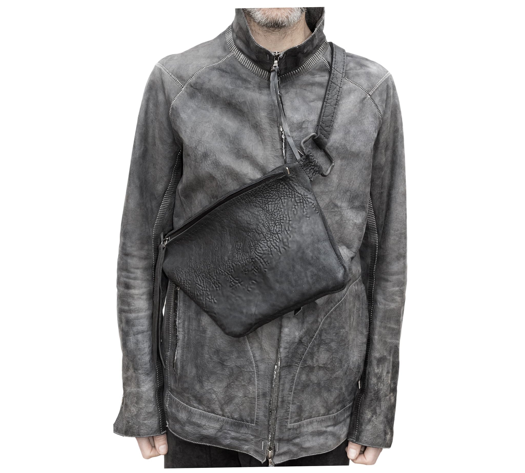 the sling bag is  patterned from a full grain reverse horse culatta leather and hand stitched with a japanese linen thread without the use of machines. the bag features a riri zipper closure, double layer hand stitched shoulder strap and hand forged iron and .925 sterling silver hardware. the rear pocket is linen with a french linen and adorned with a riri zipper and solid .925 sterling silver zipper pull. available from avant garde leather studio atelierskn.com