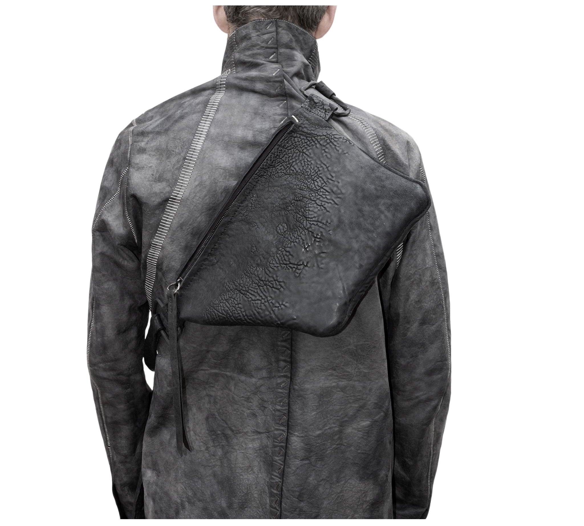 the sling bag is  patterned from a full grain reverse horse culatta leather and hand stitched with a japanese linen thread without the use of machines. the bag features a riri zipper closure, double layer hand stitched shoulder strap and hand forged iron and .925 sterling silver hardware. the rear pocket is linen with a french linen and adorned with a riri zipper and solid .925 sterling silver zipper pull. available from avant garde leather studio atelierskn.com