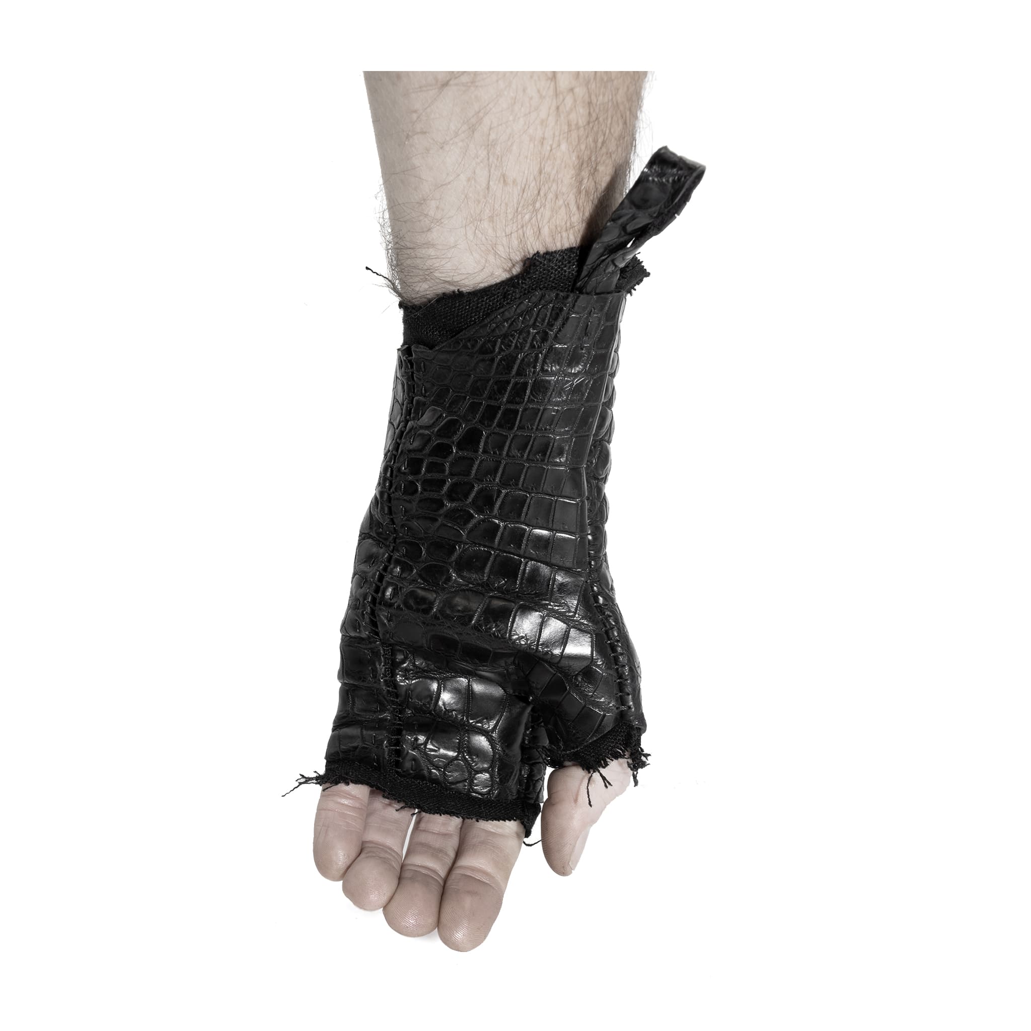 hand stitched over a 40hr period the genuine crocodile leather gloves feature deconstructed open seam panels, and a raw cut vintage french linen lining. with an object dyed finish the gloves are then wet moulded on the body over an 8 hour period for a sculptured aesthetic. the gloves are available to buy online from avant garde leather studio atelierskn.com