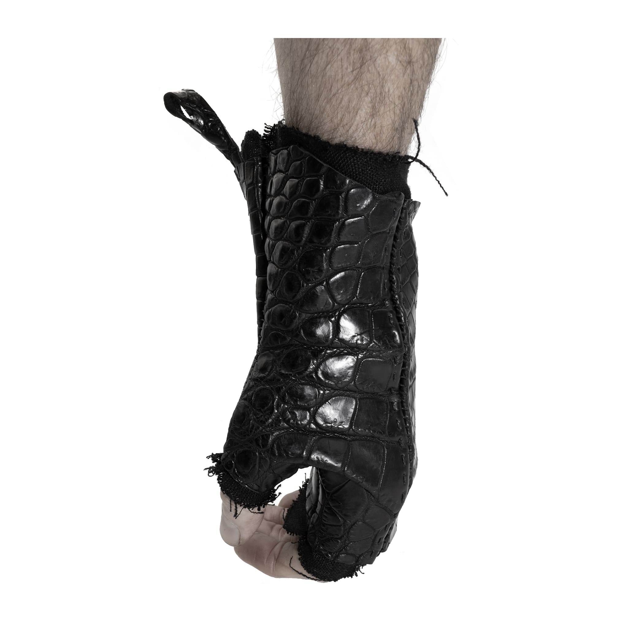 hand stitched over a 40hr period the genuine crocodile leather gloves feature deconstructed open seam panels, and a raw cut vintage french linen lining. with an object dyed finish the gloves are then wet moulded on the body over an 8 hour period for a sculptured aesthetic. the gloves are available to buy online from avant garde leather studio atelierskn.com