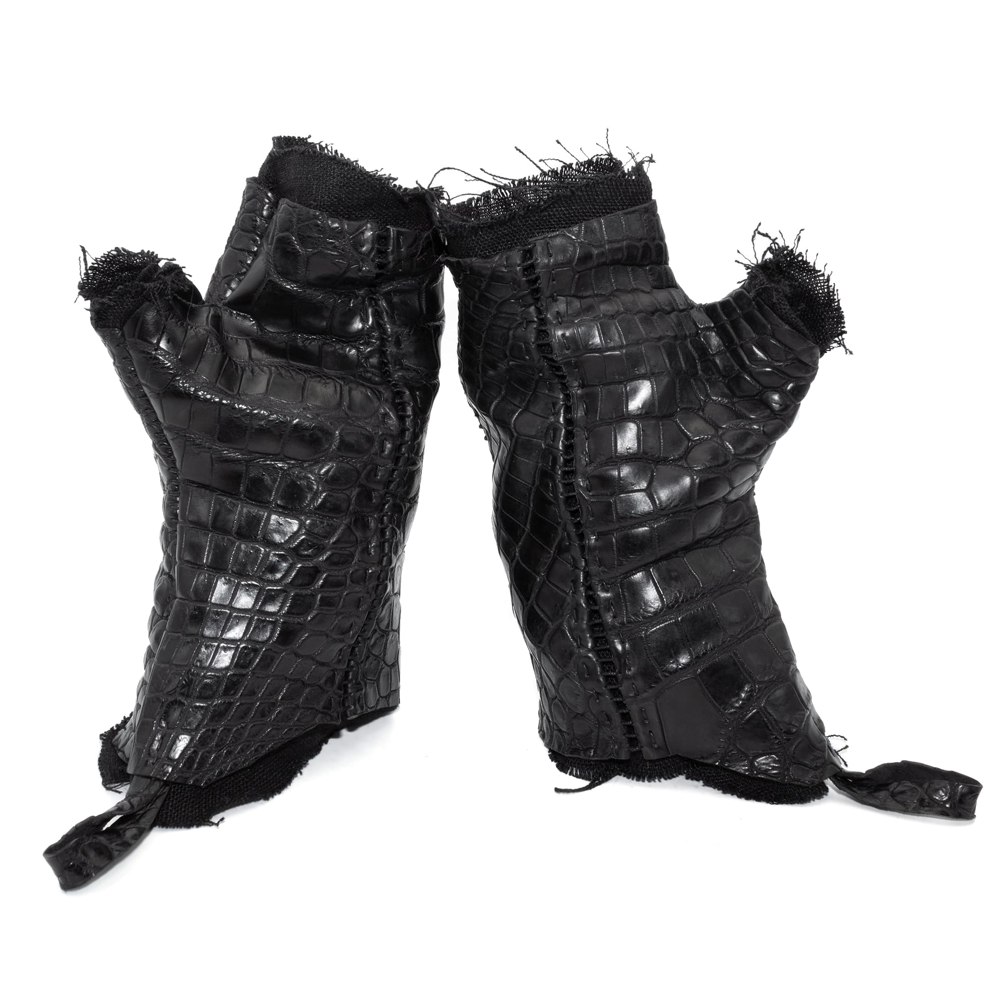 hand stitched over a 40hr period the genuine crocodile leather gloves feature deconstructed open seam panels, and a raw cut vintage french linen lining. with an object dyed finish the gloves are then wet moulded on the body over an 8 hour period for a sculptured aesthetic. the gloves are available to buy online from avant garde leather studio atelierskn.com
